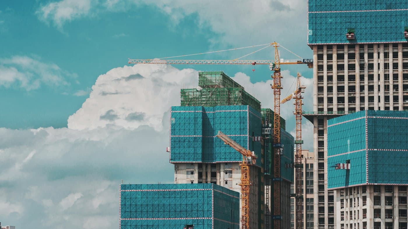 Commercial tower under construction with cranes