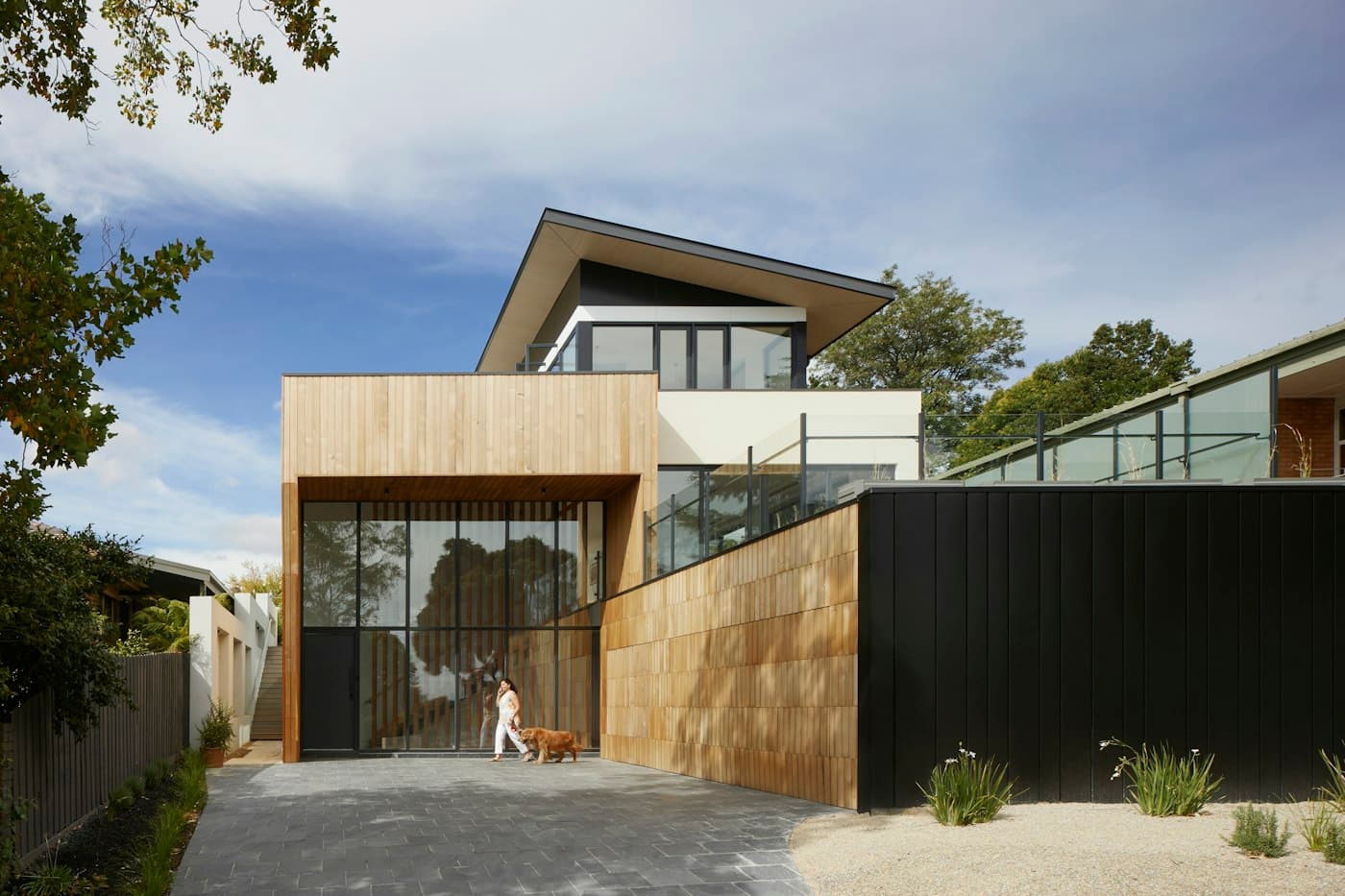 Residence facade with timber cladding and landscaped lawn