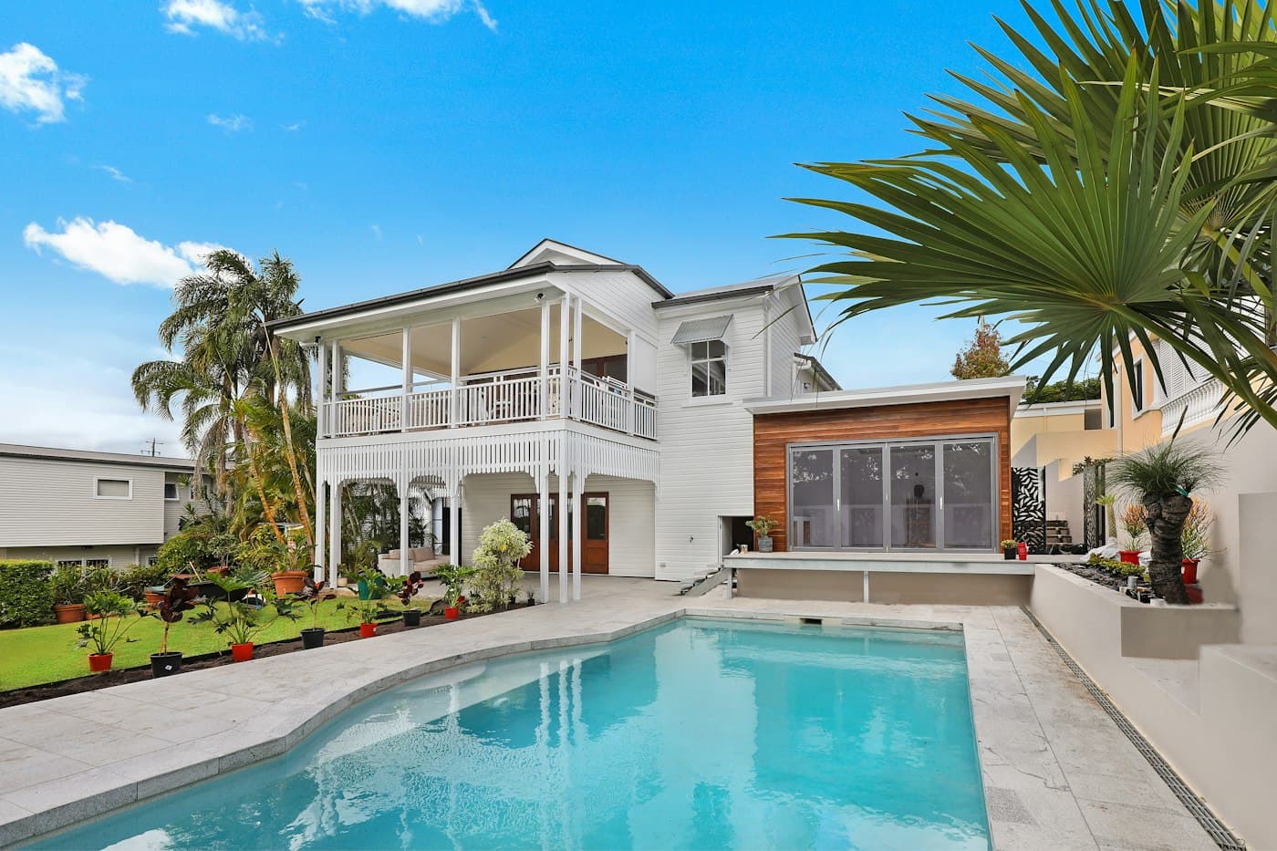 Rear elevation with pool deck and palms