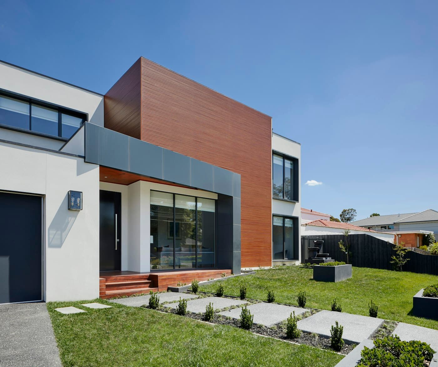 Villa facade with timber and white render