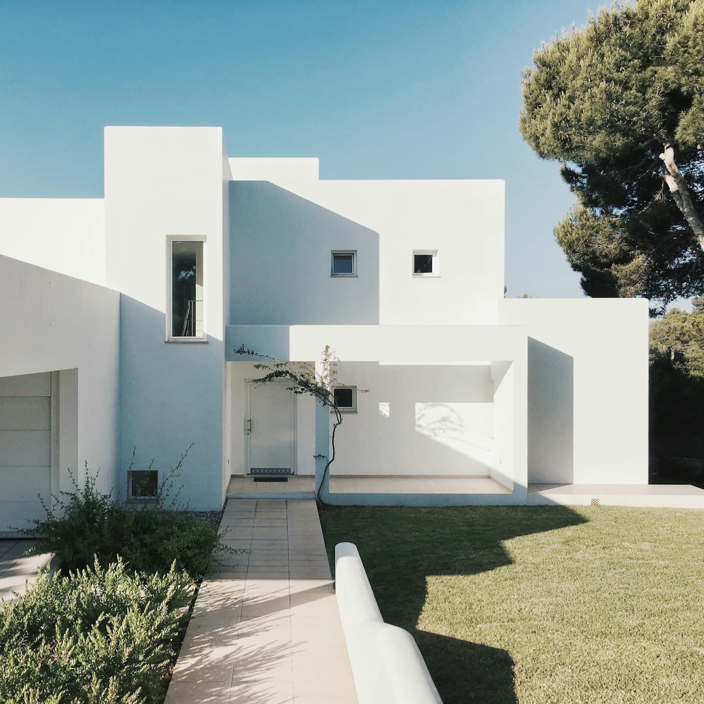 White villa with landscaped front garden